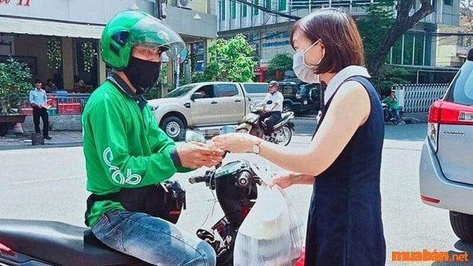 Nhân viên giao hàng đang vận chuyển hàng hóa trên đường phố vào buổi tối